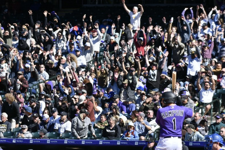 Apr 10, 2022; Denver, Colorado, USA; Colorado Rockies fans do the wave as Colorado Rockies center fielder Garrett Hampson (1) stands in the batters box during the sixth inning against the Los Angeles Dodgers at Coors Field. Mandatory Credit: John Leyba-USA TODAY Sports