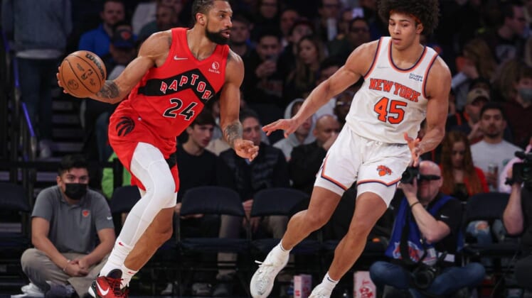 Apr 10, 2022; New York, New York, USA; Toronto Raptors center Khem Birch (24) dribbles as New York Knicks forward Jericho Sims (45) defends during the second half at Madison Square Garden. Mandatory Credit: Vincent Carchietta-USA TODAY Sports