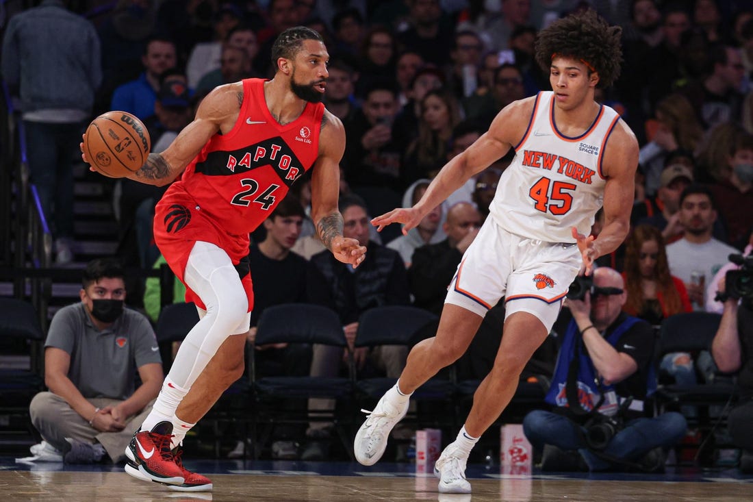 Apr 10, 2022; New York, New York, USA; Toronto Raptors center Khem Birch (24) dribbles as New York Knicks forward Jericho Sims (45) defends during the second half at Madison Square Garden. Mandatory Credit: Vincent Carchietta-USA TODAY Sports