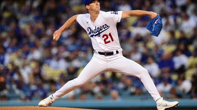 Apr 14, 2022; Los Angeles, California, USA; Los Angeles Dodgers starting pitcher Walker Buehler (21) throws against the Cincinnati Reds during the first inning at Dodger Stadium. Mandatory Credit: Gary A. Vasquez-USA TODAY Sports