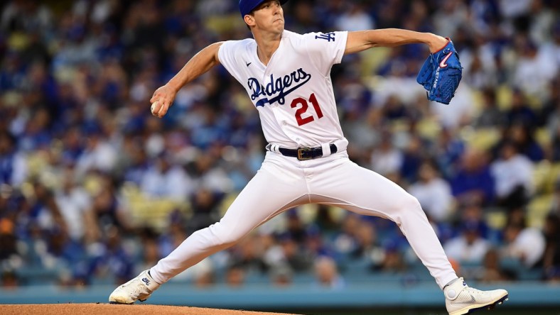 Apr 14, 2022; Los Angeles, California, USA; Los Angeles Dodgers starting pitcher Walker Buehler (21) throws against the Cincinnati Reds during the first inning at Dodger Stadium. Mandatory Credit: Gary A. Vasquez-USA TODAY Sports