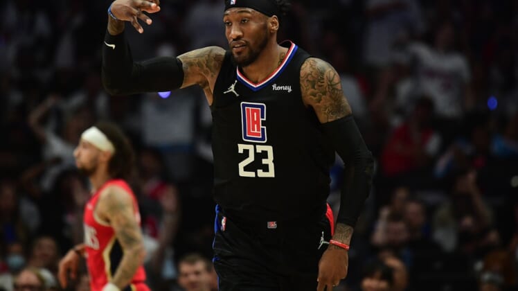 Apr 15, 2022; Los Angeles, California, USA; Los Angeles Clippers forward Robert Covington (23) reacts after scoring a three point basket against the New Orleans Pelicans during the first half of the play in game at Crypto.com Arena. Mandatory Credit: Gary A. Vasquez-USA TODAY Sports