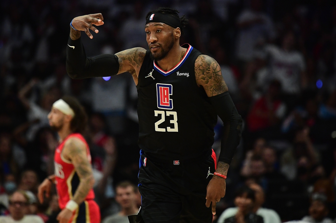 Apr 15, 2022; Los Angeles, California, USA; Los Angeles Clippers forward Robert Covington (23) reacts after scoring a three point basket against the New Orleans Pelicans during the first half of the play in game at Crypto.com Arena. Mandatory Credit: Gary A. Vasquez-USA TODAY Sports
