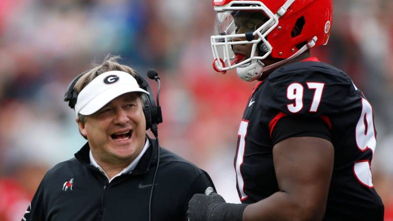 Georgia head coach Kirby Smart speaks with Georgia defensive lineman Warren Brinson (97) during the G-Day spring football game in Athens, Ga., on Saturday, April 16, 2022.

News Joshua L Jones