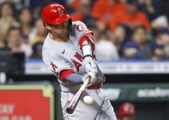 Apr 19, 2022; Houston, Texas, USA; Los Angeles Angels catcher Kurt Suzuki (24) hits a RBI single against the Houston Astros in the fifth inning at Minute Maid Park. Mandatory Credit: Thomas Shea-USA TODAY Sports