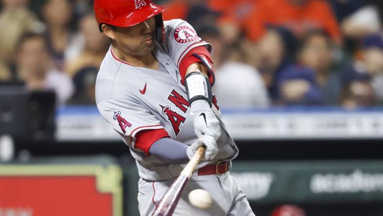 Apr 19, 2022; Houston, Texas, USA; Los Angeles Angels catcher Kurt Suzuki (24) hits a RBI single against the Houston Astros in the fifth inning at Minute Maid Park. Mandatory Credit: Thomas Shea-USA TODAY Sports