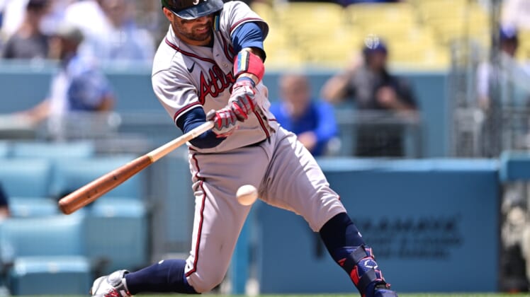 Apr 20, 2022; Los Angeles, California, USA;  Atlanta Braves catcher Manny Pina (9) singles in the fifth inning at Dodger Stadium. Mandatory Credit: Jayne Kamin-Oncea-USA TODAY Sports