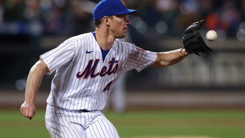 Apr 20, 2022; New York City, New York, USA; New York Mets starting pitcher Chris Bassitt (40) catches the ball for an out at first base during the fourth inning against the San Francisco Giants at Citi Field. Mandatory Credit: Vincent Carchietta-USA TODAY Sports