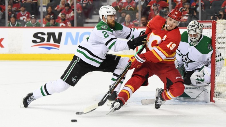 Apr 21, 2022; Calgary, Alberta, CAN; Dallas Stars defenseman Jani Hakanpaa (2) defends against Calgary Flames forward Matthew Tkachuk (19) during the third period at Scotiabank Saddledome. Flames won 4-2. Mandatory Credit: Candice Ward-USA TODAY Sports