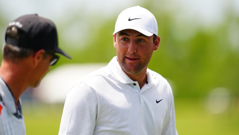 Apr 22, 2022; Avondale, Louisiana, USA; Scottie Scheffler talks to his caddie on the ninth hole green during the second round of the Zurich Classic of New Orleans golf tournament. Mandatory Credit: Andrew Wevers-USA TODAY Sports