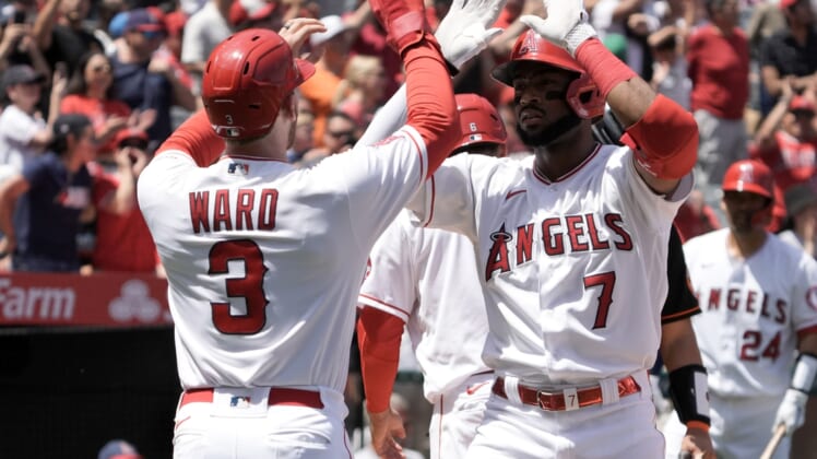 Apr 24, 2022; Anaheim, California, USA; Los Angeles Angels left fielder Jo Adell (7) celebrates with right fielder Taylor Ward (3) after hitting a grand slam home run in the first inning against the Baltimore Orioles at Angel Stadium. Mandatory Credit: Kirby Lee-USA TODAY Sports