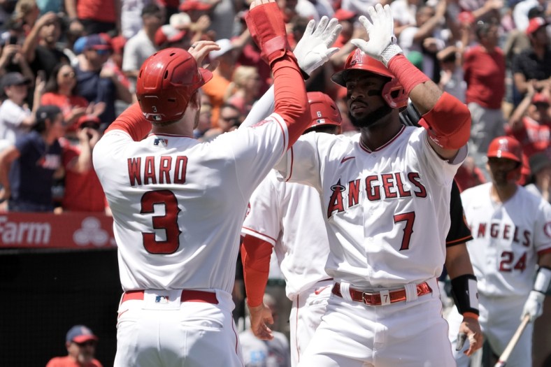 Apr 24, 2022; Anaheim, California, USA; Los Angeles Angels left fielder Jo Adell (7) celebrates with right fielder Taylor Ward (3) after hitting a grand slam home run in the first inning against the Baltimore Orioles at Angel Stadium. Mandatory Credit: Kirby Lee-USA TODAY Sports