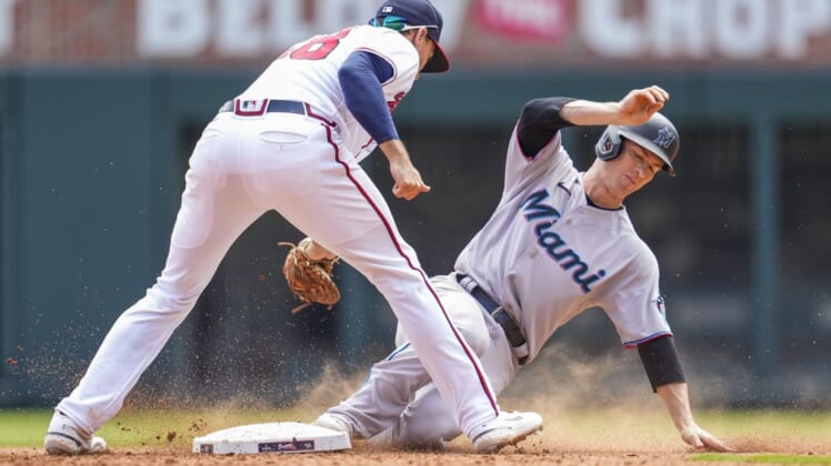Apr 24, 2022; Cumberland, Georgia, USA; Miami Marlins shortstop Joey Wendle (18) slides into second base under a tag by Atlanta Braves first baseman Matt Olson (28) during the seventh inning at Truist Park. Mandatory Credit: Dale Zanine-USA TODAY Sports