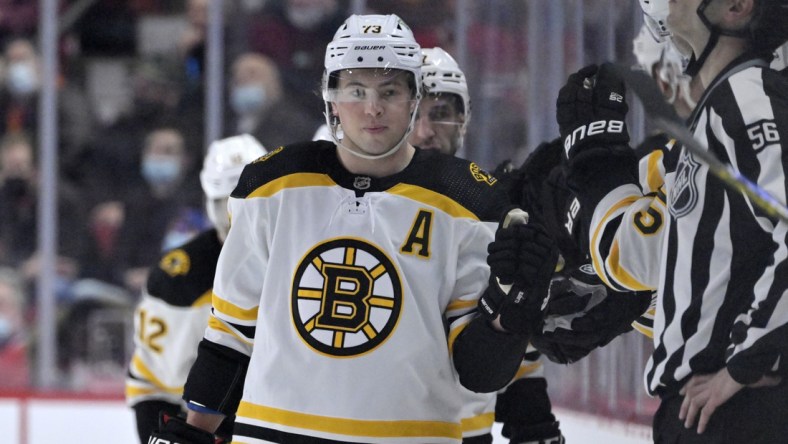 Apr 24, 2022; Montreal, Quebec, CAN; Boston Bruins defenseman Charlie McAvoy (73) celebrates with teammates after scoring a goal against the Montreal Canadiens during the second period at the Bell Centre. Mandatory Credit: Eric Bolte-USA TODAY Sports