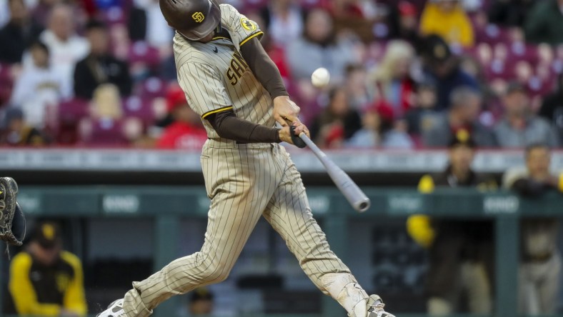 Apr 26, 2022; Cincinnati, Ohio, USA; San Diego Padres right fielder Wil Myers (5) hits a single against the Cincinnati Reds in the fifth inning at Great American Ball Park. Mandatory Credit: Katie Stratman-USA TODAY Sports