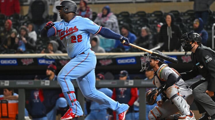 Apr 26, 2022; Minneapolis, Minnesota, USA; Minnesota Twins first baseman Miguel Sano (22) hits a single in the ninth inning against the Detroit Tigers at Target Field. Mandatory Credit: Nick Wosika-USA TODAY Sports