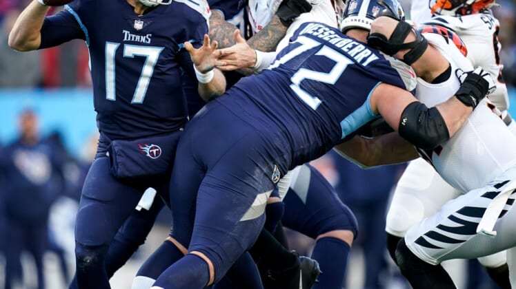 Tennessee Titans quarterback Ryan Tannehill (17) evades Cincinnati Bengals defenders during the first quarter of an AFC Divisional playoff game at Nissan Stadium Saturday, Jan. 22, 2022 in Nashville, Tenn.Titans Bengals 012222 An 009
