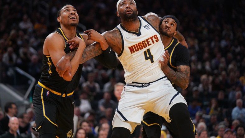 Apr 27, 2022; San Francisco, California, USA; Denver Nuggets center DeMarcus Cousins (4) battles for position with Golden State Warriors forward Otto Porter Jr. (32) and guard Gary Payton II (0) in the fourth quarter during game five of the first round for the 2022 NBA playoffs at Chase Center. Mandatory Credit: Cary Edmondson-USA TODAY Sports