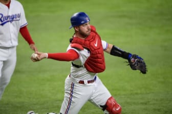 Apr 28, 2022; Arlington, Texas, USA; Texas Rangers catcher Mitch Garver (18) throws out Houston Astros right fielder Chas McCormick (not pictured) during the first inning at Globe Life Field. Mandatory Credit: Jerome Miron-USA TODAY Sports