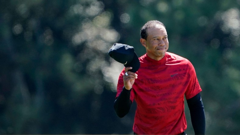 Tiger Woods tips his hat to the fans as they applaud as he walks up No. 18 during the final round of the Masters at Augusta National Golf Club.

2022-4-10-tiger-woods-cap