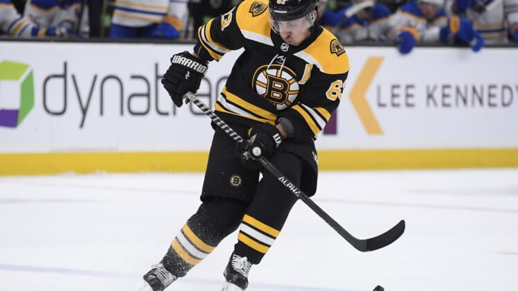Apr 28, 2022; Boston, Massachusetts, USA;  Boston Bruins left wing Brad Marchand (63) blocks the puck from going out of the zone during the second period against the Buffalo Sabres at TD Garden. Mandatory Credit: Bob DeChiara-USA TODAY Sports