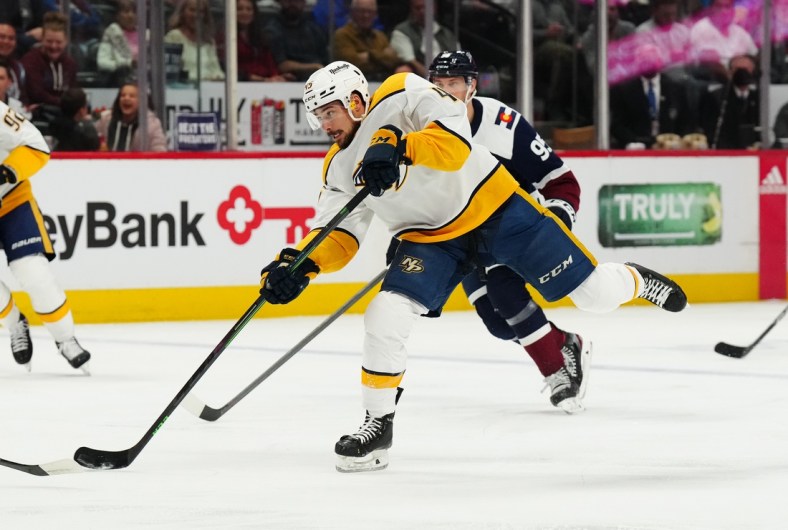 Apr 28, 2022; Denver, Colorado, USA; Nashville Predators defenseman Alexandre Carrier (45) shoots the puck in the first period against the Colorado Avalanche at Ball Arena. Mandatory Credit: Ron Chenoy-USA TODAY Sports
