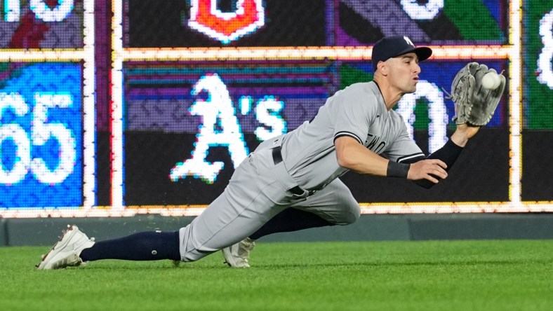 Apr 29, 2022; Kansas City, Missouri, USA; New York Yankees left fielder Tim Locastro (33) catches a line drive during the fifth inning against the Kansas City Royals at Kauffman Stadium. Mandatory Credit: Jay Biggerstaff-USA TODAY Sports