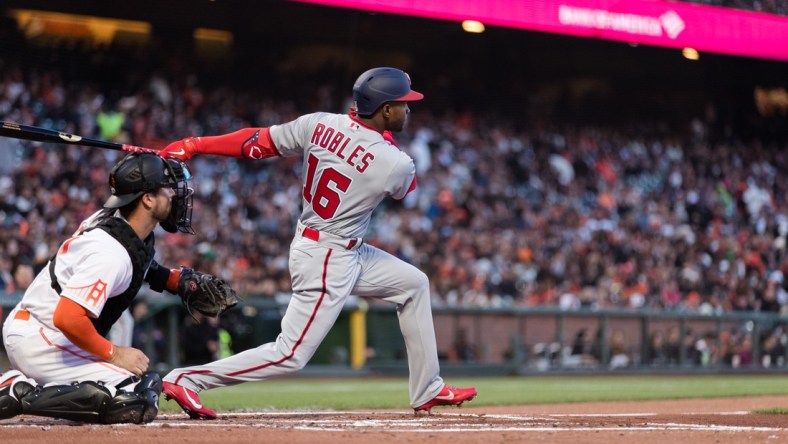 Apr 29, 2022; San Francisco, California, USA; Washington Nationals center fielder Victor Robles (16) hits and RBI double against the San Francisco Giants during the second inning at Oracle Park. Mandatory Credit: John Hefti-USA TODAY Sports