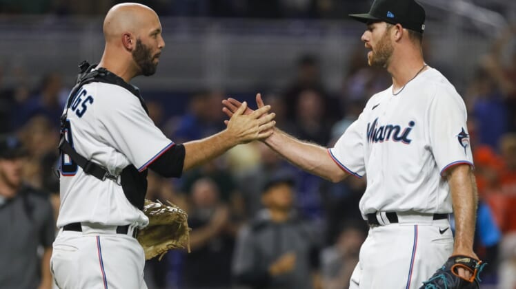 Apr 30, 2022; Miami, Florida, USA; Miami Marlins catcher Jacob Stallings (left) celebrates with relief pitcher Anthony Bender (55) after defeating the Seattle Mariners at loanDepot Park. Mandatory Credit: Sam Navarro-USA TODAY Sports