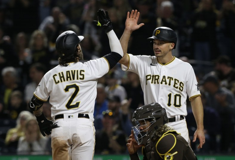 Apr 30, 2022; Pittsburgh, Pennsylvania, USA;  Pittsburgh Pirates first baseman Michael Chavis (2) celebrates his two run home run with left fielder Bryan Reynolds (10) against the San Diego Padres during the eighth inning at PNC Park. Mandatory Credit: Charles LeClaire-USA TODAY Sports