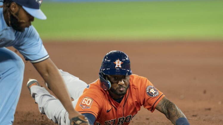 May 1, 2022; Toronto, Ontario, CAN; Houston Astros second baseman Niko Goodrum (11) is tagged out by Toronto Blue Jays first baseman Vladimir Guerrero Jr. (27) during the fifth inning at Rogers Centre. Mandatory Credit: Nick Turchiaro-USA TODAY Sports