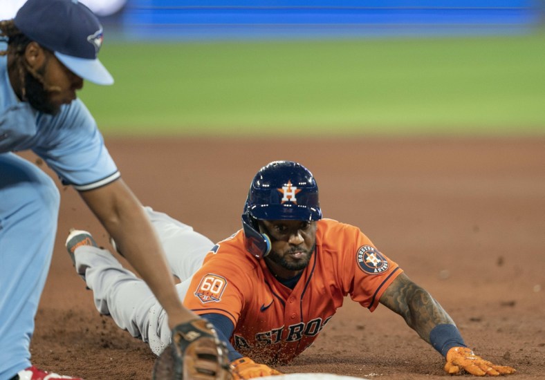 May 1, 2022; Toronto, Ontario, CAN; Houston Astros second baseman Niko Goodrum (11) is tagged out by Toronto Blue Jays first baseman Vladimir Guerrero Jr. (27) during the fifth inning at Rogers Centre. Mandatory Credit: Nick Turchiaro-USA TODAY Sports