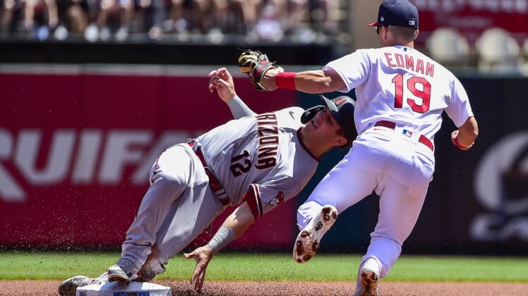 May 1, 2022; St. Louis, Missouri, USA;  Arizona Diamondbacks catcher Daulton Varsho (12) is tagged out by St. Louis Cardinals second baseman Tommy Edman (19) on a stolen base attempt during the first inning at Busch Stadium. Mandatory Credit: Jeff Curry-USA TODAY Sports