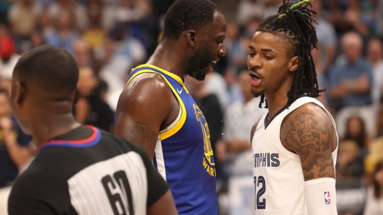 May 1, 2022; Memphis, Tennessee, USA; Golden State Warriors forward Draymond Green (23) and Memphis Grizzlies guard Ja Morant (12) have words during game one of the second round for the 2022 NBA playoffs at FedExForum. Mandatory Credit: Joe Rondone-USA TODAY Sports