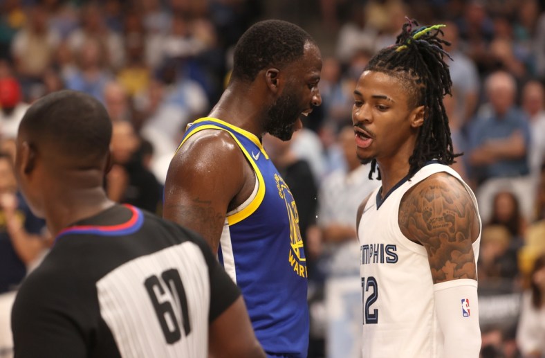 May 1, 2022; Memphis, Tennessee, USA; Golden State Warriors forward Draymond Green (23) and Memphis Grizzlies guard Ja Morant (12) have words during game one of the second round for the 2022 NBA playoffs at FedExForum. Mandatory Credit: Joe Rondone-USA TODAY Sports
