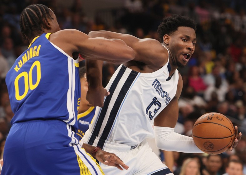 May 1, 2022; Memphis, Tennessee, USA; Memphis Grizzlies forward Jaren Jackson jr. (13) drives past Golden State Warriors forward Jonathan Kuminga (00) during game one of the second round for the 2022 NBA playoffs at FedExForum. Mandatory Credit: Joe Rondone-USA TODAY Sports