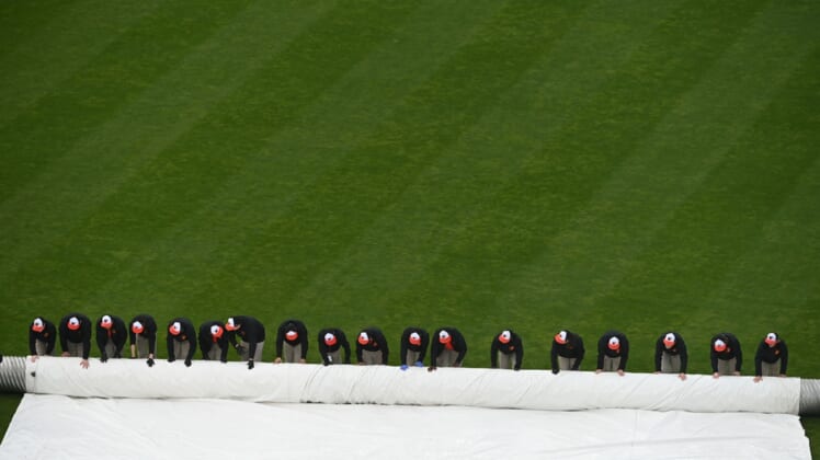 May 1, 2022; Baltimore, Maryland, USA; Baltimore Orioles grounds crew rolls the tarp after a rain delay in the game against the Boston Red Sox  at Oriole Park at Camden Yards. Mandatory Credit: Tommy Gilligan-USA TODAY Sports