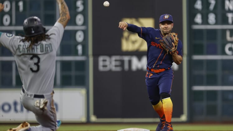 May 2, 2022; Houston, Texas, USA; Seattle Mariners shortstop J.P. Crawford (3) is out as Houston Astros second baseman Jose Altuve (27) throws to first base to complete a double play during the fifth inning at Minute Maid Park. Mandatory Credit: Troy Taormina-USA TODAY Sports