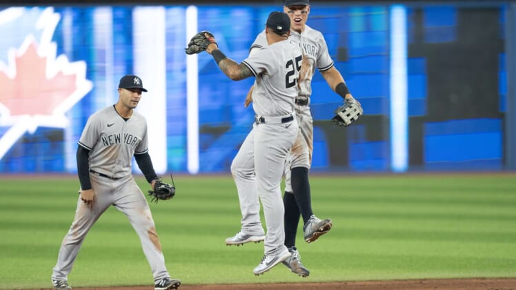 May 2, 2022; Toronto, Ontario, CAN; New York Yankees right fielder Aaron Judge (99) celebrates the win with New York Yankees second baseman Gleyber Torres (25) at the end of the ninth inning against the Toronto Blue Jays at Rogers Centre. Mandatory Credit: Nick Turchiaro-USA TODAY Sports