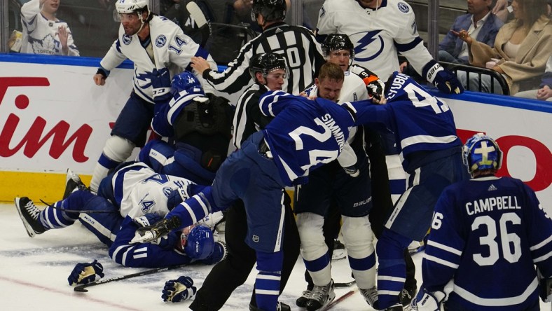 May 2, 2022; Toronto, Ontario, CAN; Tampa Bay Lightning forward Corey Perry (10) fights with Toronto Maple Leafs forward Wayne Simmonds (24) and forward Ilya Lyubushkin (46) during the third period of game one of the first round of the 2022 Stanley Cup Playoffs at Scotiabank Arena. Mandatory Credit: John E. Sokolowski-USA TODAY Sports