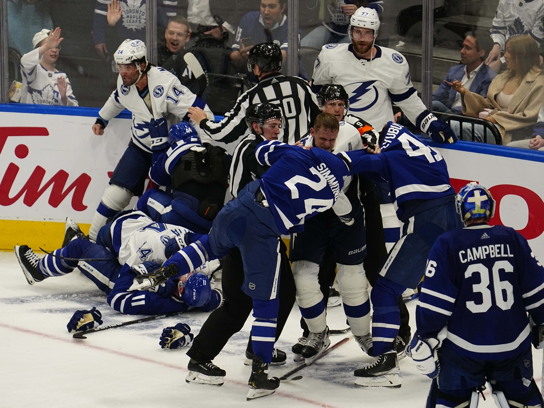 May 2, 2022; Toronto, Ontario, CAN; Tampa Bay Lightning forward Corey Perry (10) fights with Toronto Maple Leafs forward Wayne Simmonds (24) and forward Ilya Lyubushkin (46) during the third period of game one of the first round of the 2022 Stanley Cup Playoffs at Scotiabank Arena. Mandatory Credit: John E. Sokolowski-USA TODAY Sports