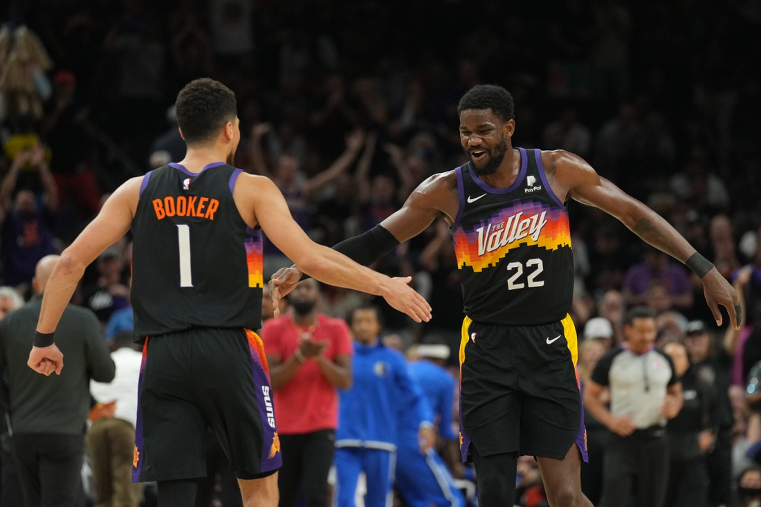 May 2, 2022; Phoenix, Arizona, USA; Phoenix Suns guard Devin Booker (1) and Phoenix Suns center Deandre Ayton (22) slap hands against the Dallas Mavericks during the first half of game one of the second round for the 2022 NBA playoffs at Footprint Center. Mandatory Credit: Joe Camporeale-USA TODAY Sports