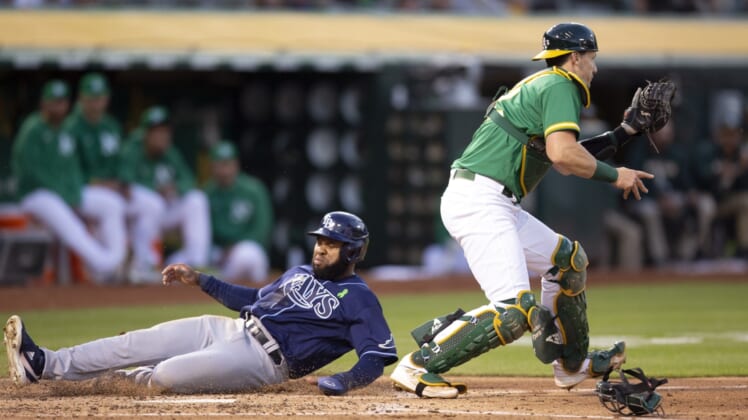 May 2, 2022; Oakland, California, USA; Tampa Bay Rays right fielder Manuel Margot (13) slides safely home past Oakland Athletics catcher Sean Murphy (12) on a single by Mike Zunino during the fourth inning at RingCentral Coliseum. Mandatory Credit: D. Ross Cameron-USA TODAY Sports