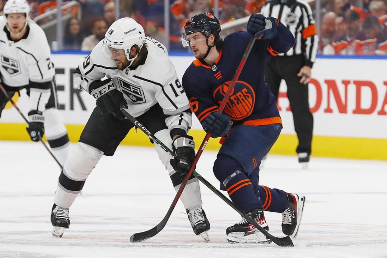 May 2, 2022; Edmonton, Alberta, CAN; Los Angeles Kings forward Alex Iafallo (19) and Edmonton Oilers forward Kailer Yamamoto (56) play for position during the second period in game one of the first round of the 2022 Stanley Cup Playoffs at Rogers Place. Mandatory Credit: Perry Nelson-USA TODAY Sports
