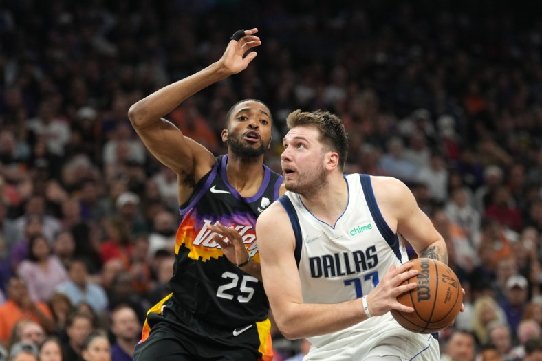 May 2, 2022; Phoenix, Arizona, USA; Dallas Mavericks guard Luka Doncic (77) drives against Phoenix Suns forward Mikal Bridges (25) during the second half of game one of the second round for the 2022 NBA playoffs against the Dallas Mavericks at Footprint Center. Mandatory Credit: Joe Camporeale-USA TODAY Sports