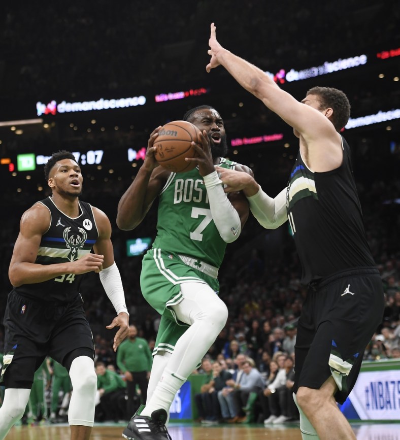 May 3, 2022; Boston, Massachusetts, USA; Boston Celtics guard Jaylen Brown (7) drives to the basket while Milwaukee Bucks center Brook Lopez (11) defends in the first half during game two of the second round for the 2022 NBA playoffs at TD Garden. Mandatory Credit: Bob DeChiara-USA TODAY Sports