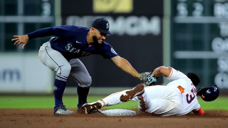 May 3, 2022; Houston, Texas, USA; Houston Astros shortstop Jeremy Pena (3) slides into second base while beating the tag by Seattle Mariners third baseman Abraham Toro (13) during the third inning at Minute Maid Park. Mandatory Credit: Erik Williams-USA TODAY Sports