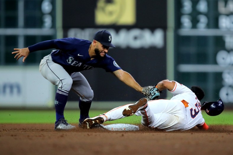 May 3, 2022; Houston, Texas, USA; Houston Astros shortstop Jeremy Pena (3) slides into second base while beating the tag by Seattle Mariners third baseman Abraham Toro (13) during the third inning at Minute Maid Park. Mandatory Credit: Erik Williams-USA TODAY Sports
