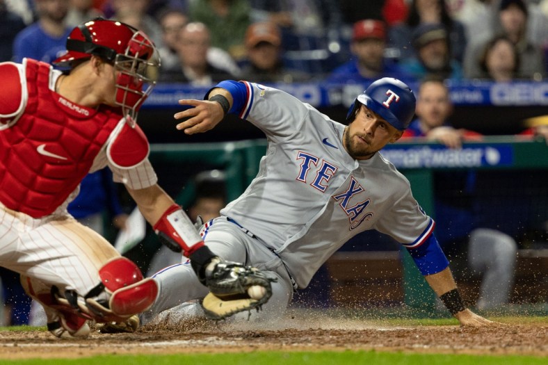 May 3, 2022; Philadelphia, Pennsylvania, USA; Texas Rangers first baseman Nathaniel Lowe (30) slides safely into homeplate past Philadelphia Phillies catcher J.T. Realmuto (10) for a run during the sixth inning at Citizens Bank Park. Mandatory Credit: Bill Streicher-USA TODAY Sports