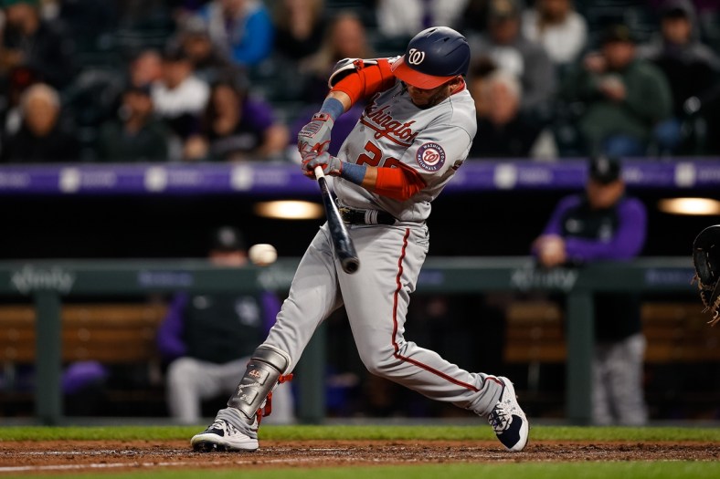 May 3, 2022; Denver, Colorado, USA; Washington Nationals left fielder Yadiel Hernandez (29) hits a single in the fifth inning against the Colorado Rockies at Coors Field. Mandatory Credit: Isaiah J. Downing-USA TODAY Sports